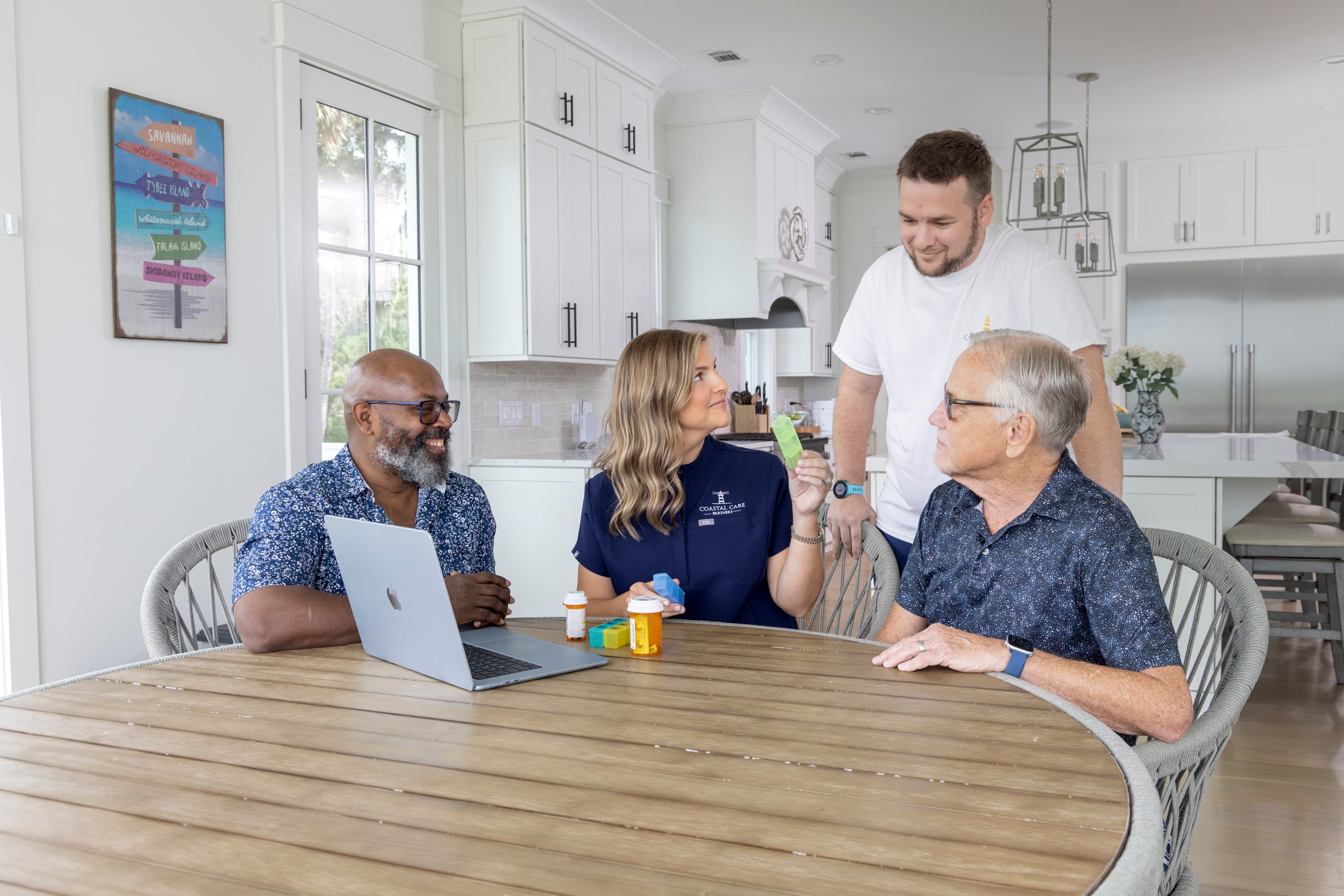 Care manager with clients and caregiver at table